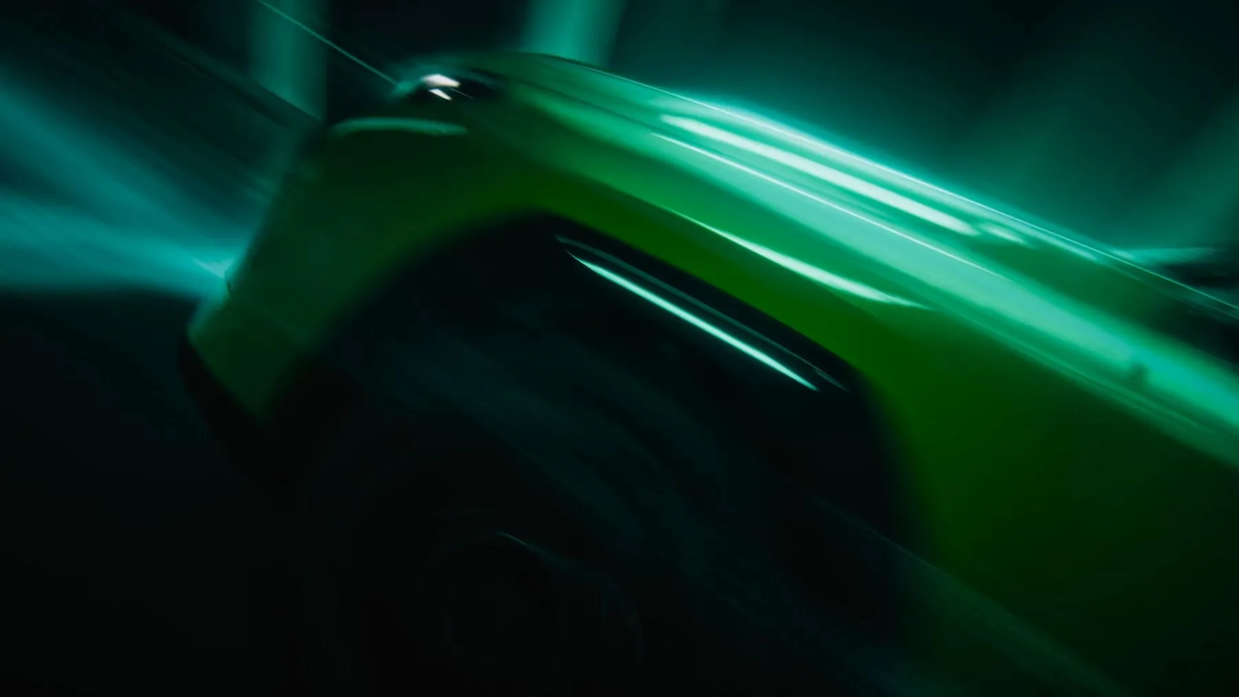 The car’s bodywork sweeping past in green light