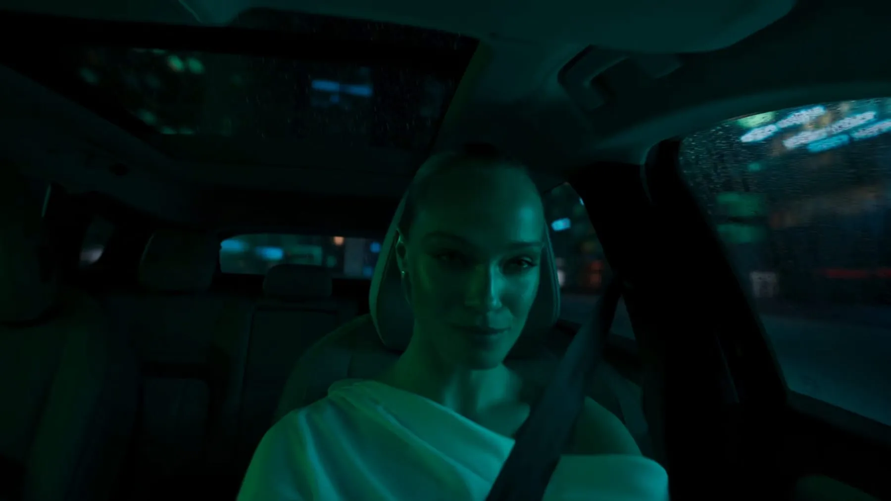 The driver at the wheel, cabin lit in cold green