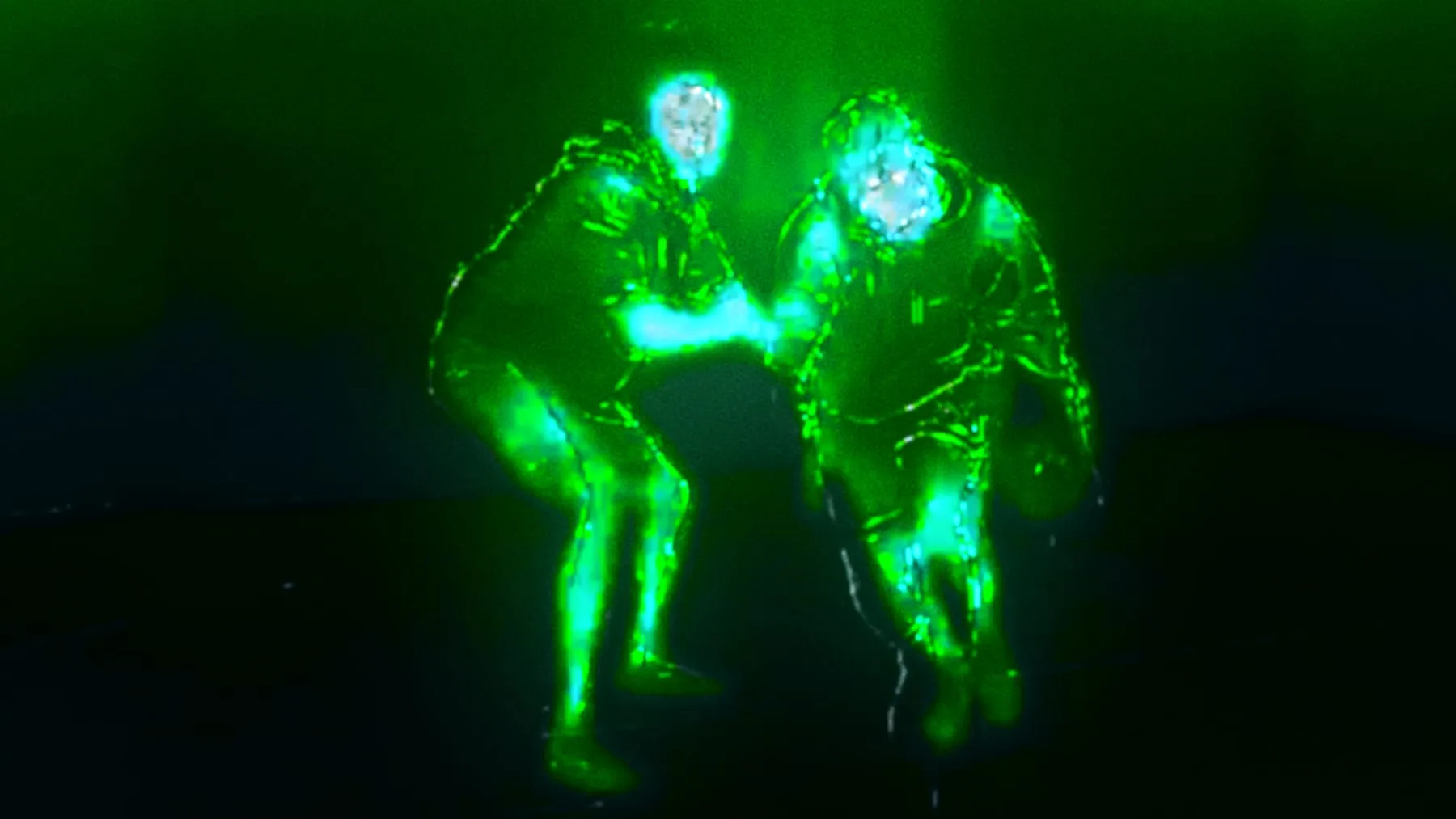 Two players rendered as green energy, mid-contest