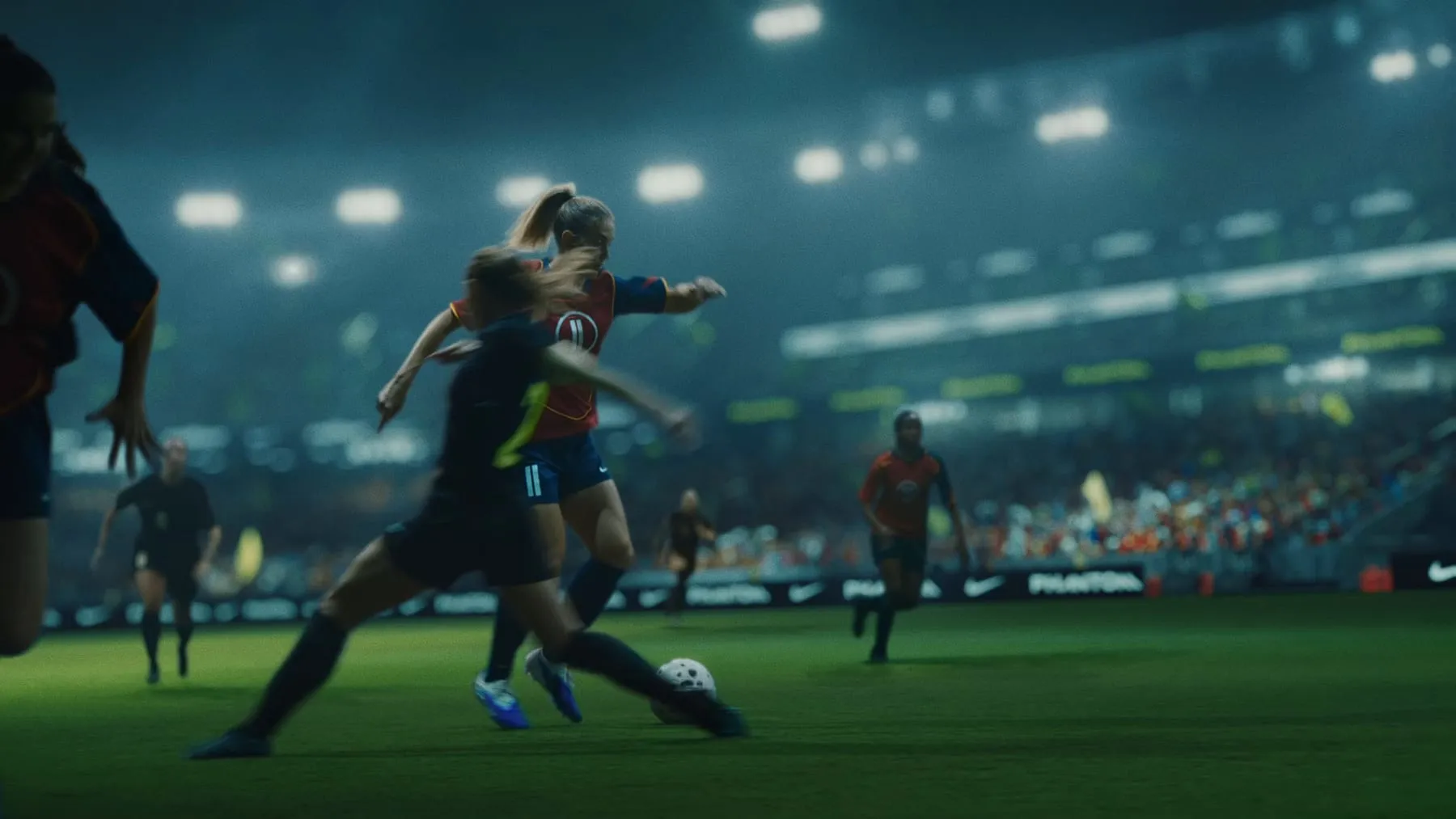 Alexia Putellas driving forward with the ball, floodlit stadium behind