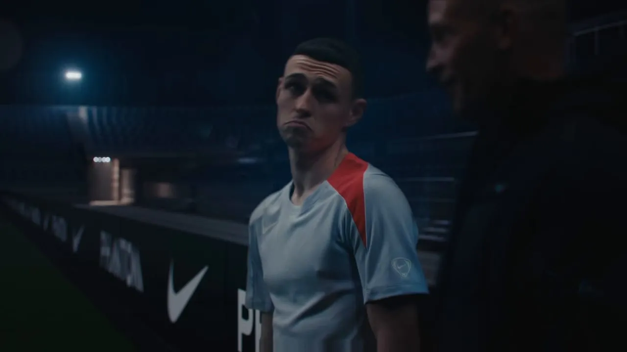 Phil Foden pitchside, caught mid-expression