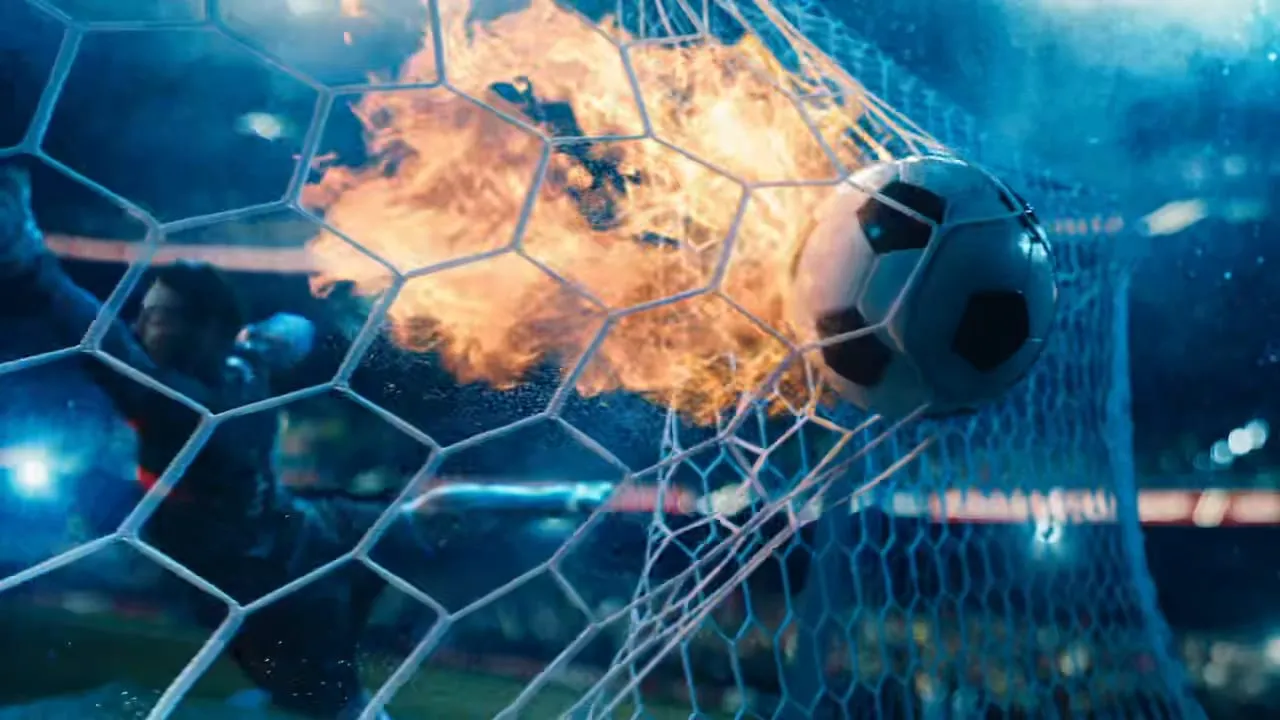 A football hitting the net, the strike still burning