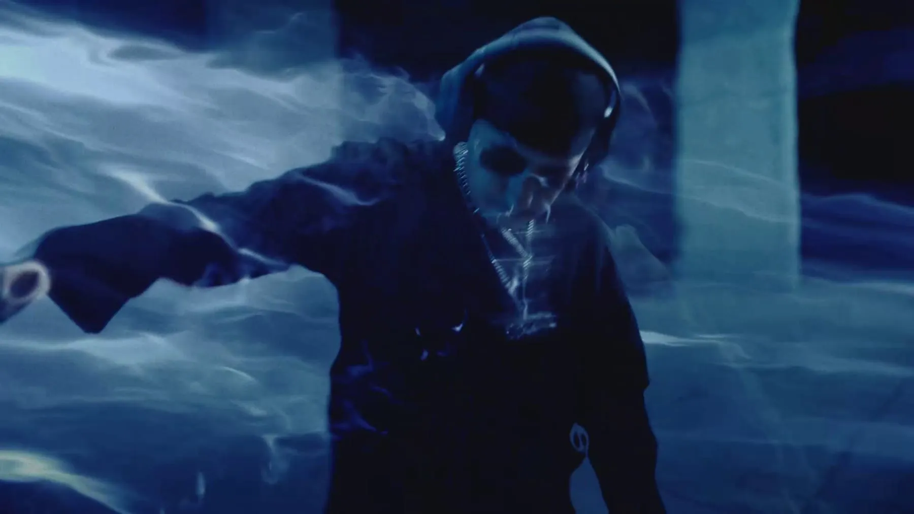 A figure wrapped in blue smoke under concrete columns