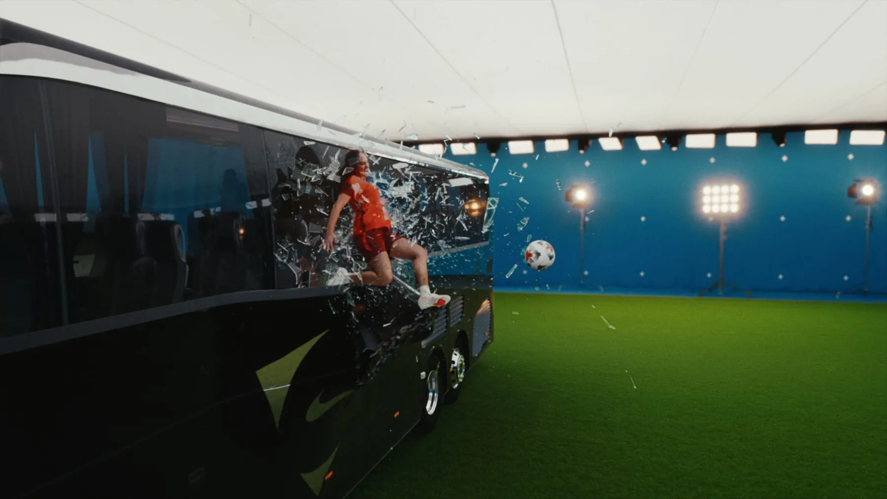 A player bursting through the side of a black coach, glass and panels in the air