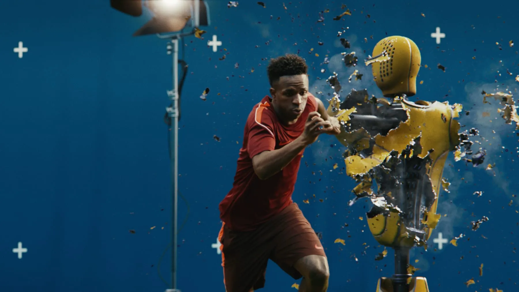 A player driving through a yellow training dummy as it shatters into debris