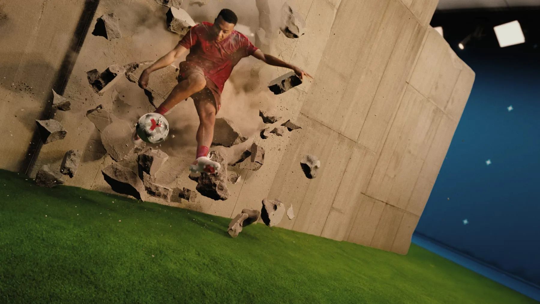 A player breaking through a concrete wall, blocks and dust flying