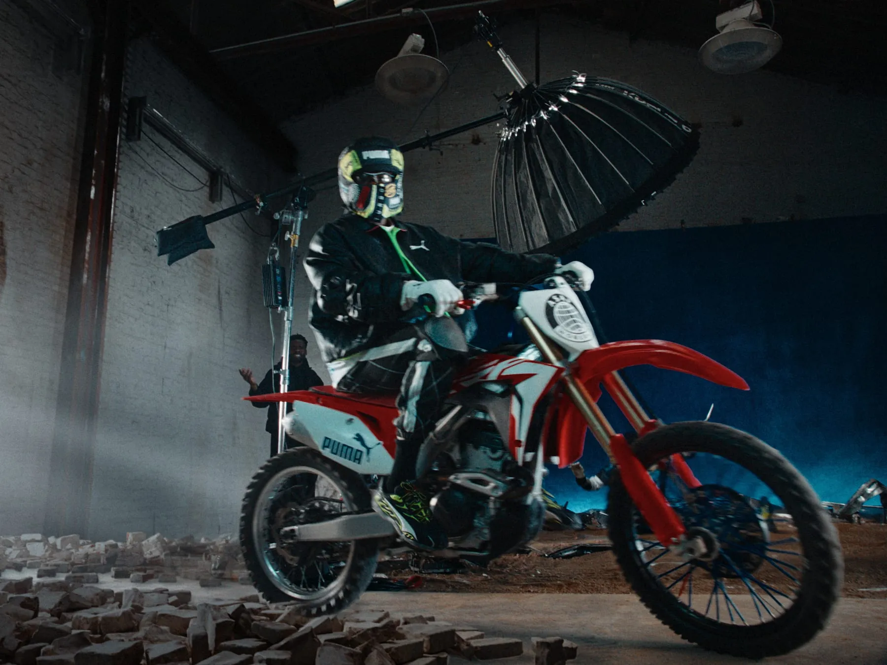 A motorcycle in a warehouse, beams of light cutting across the floor