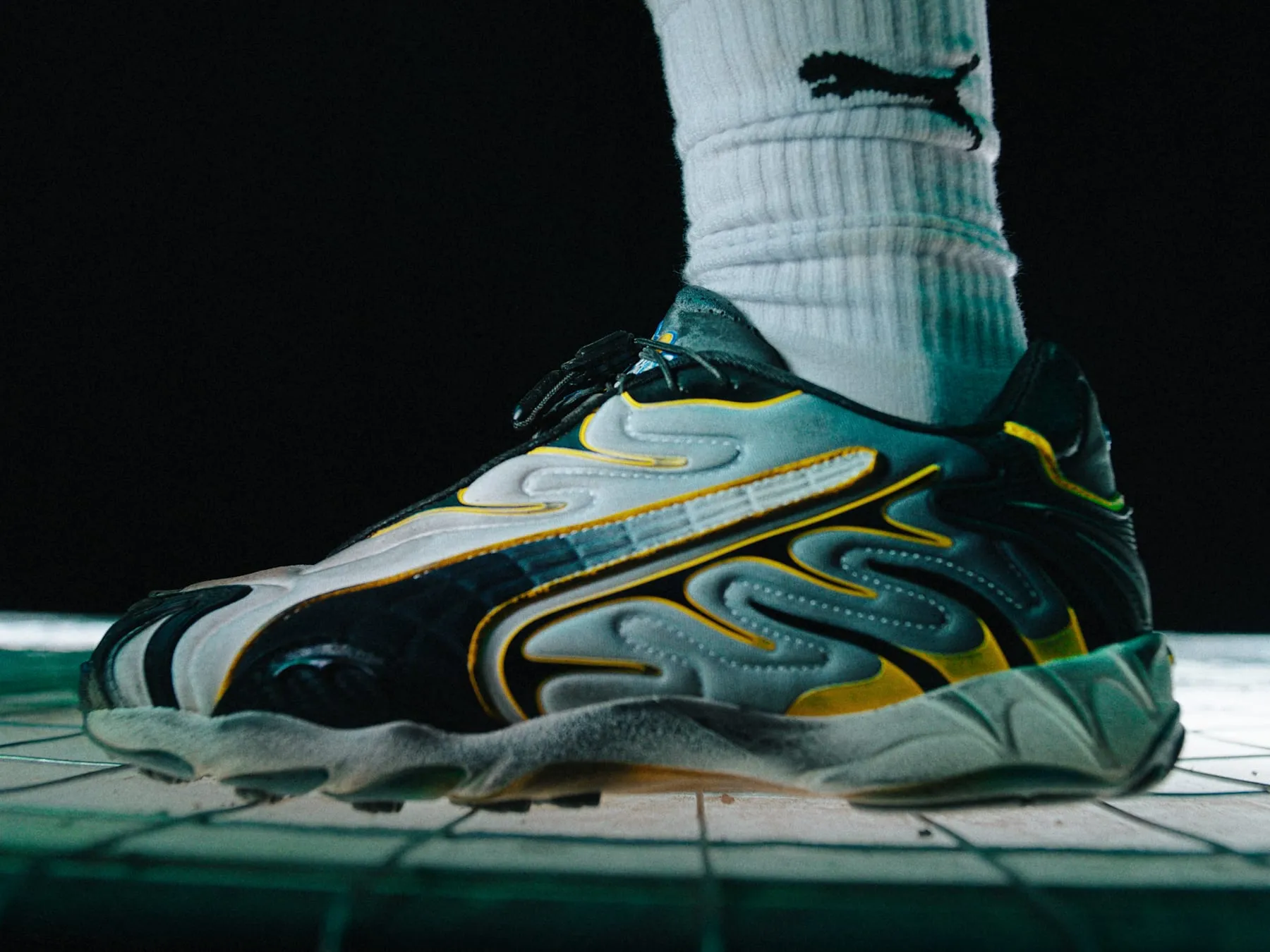 The PUMA Mostro, shot as a packshot above the sock line