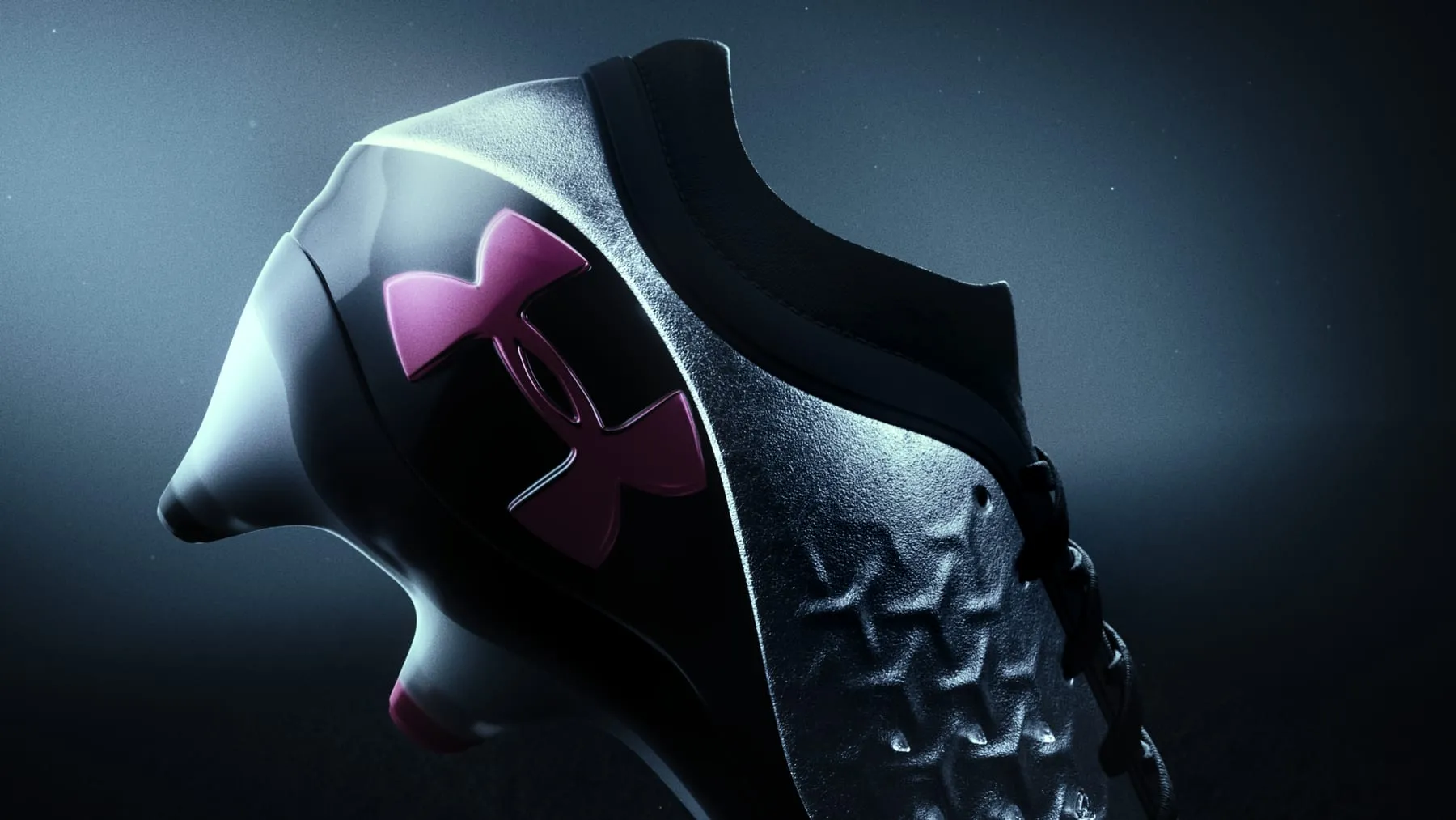 Three-quarter view of the boot, magenta Under Armour logo catching the light