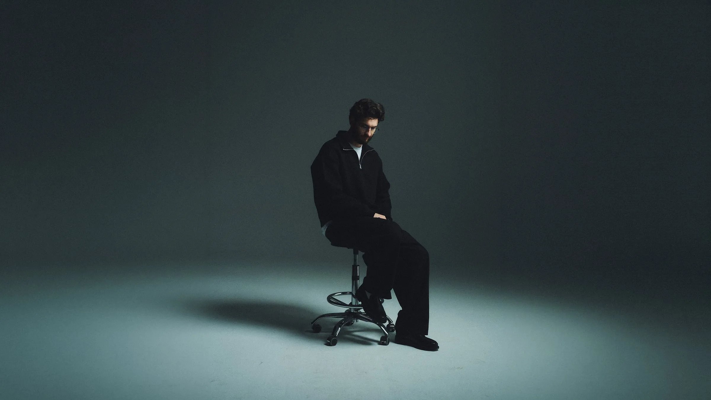 Yaroslav Klopotenko in the studio, seated on a stool